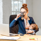Mum sits on a tree branch in the park and puts a hungry baby to her breast, which greedily sucks natural and nutritious mother's milk. The woman supports the girl, putting her to her breast properly.